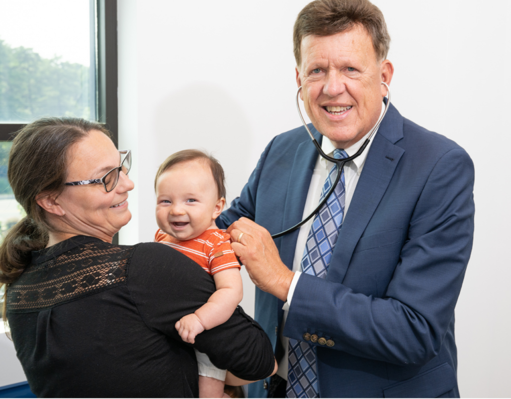 doctor examining child with mother